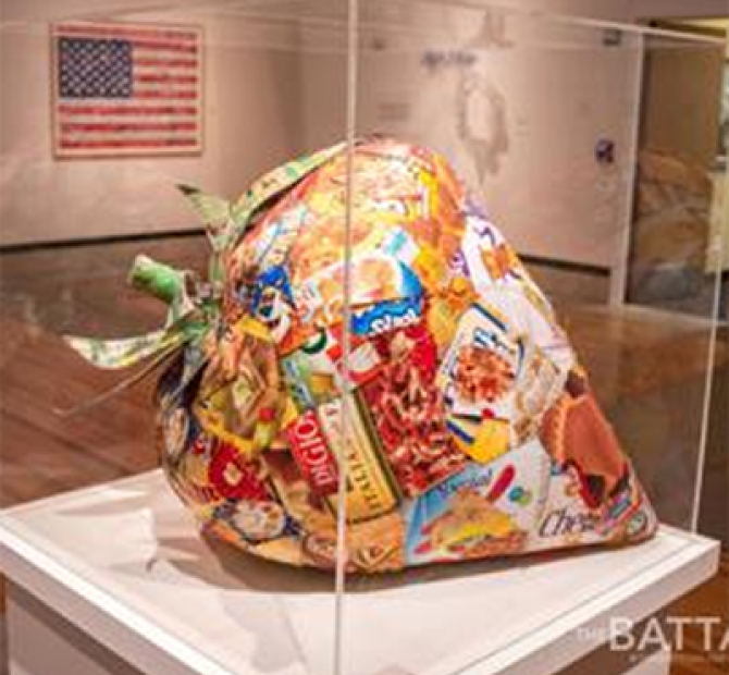 Large paper mache strawberry made out of food labels