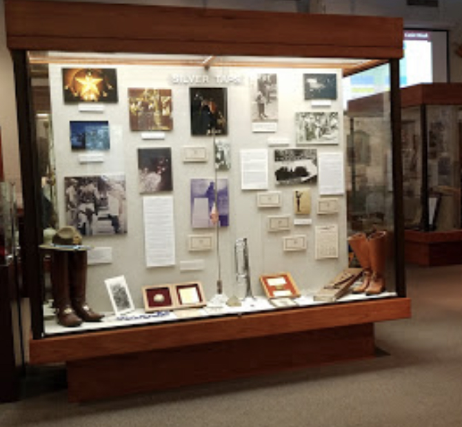 Glass display case showing pictures and memorabilia from Texas A&M's Corps of Cadets