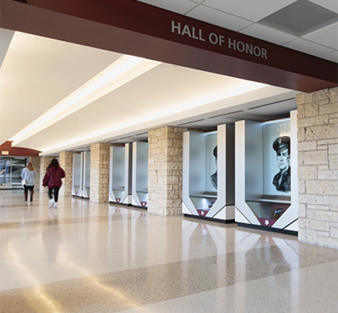 Long hallway with a maroon beam above the threshold that reads 'Hall of Honor'