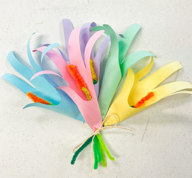 Bouquet of flowers made of pastel colored paper, pipe cleaners and ribbon