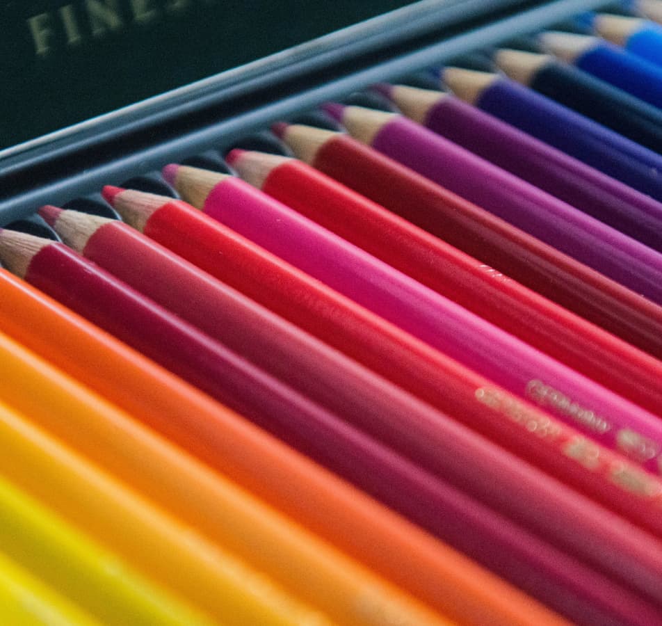 Close up image of colored pencils in rainbow order
